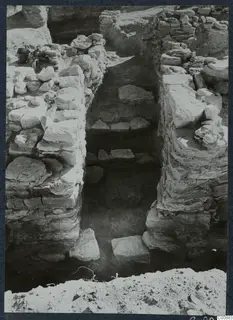 Excavated trench at Idalion Acropolis with stone walls and flat stones lying on its floor and ledges