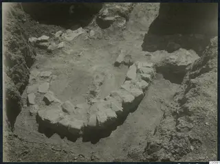 Excavation trench at Idalion with a curved line of stones set into the soil.