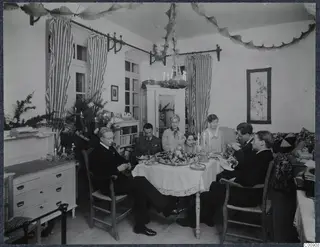 Christmas Eve breakfast table in Nicosia, with seven people seated around it in a decorated room