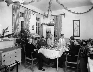 Christmas Eve 1927, breakfast table, Nicosia: seven people seated around a table laid with fruit and candles
