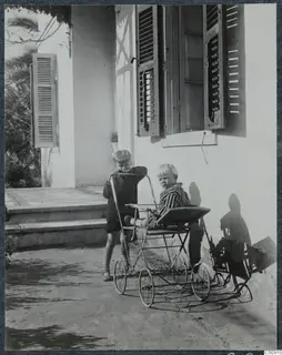 Martin and Stefan Gjerstad with a metal pram outside a whitewashed house in Nicosia.