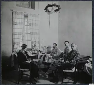 Rosa Lindros, Alfred Westholm, Erik Sjoqvist and John Lindros in a room with a table and bed in Nicosia.