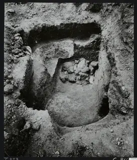 Tomb 427 at Lapithos during excavation, with loose stones in the tomb chamber