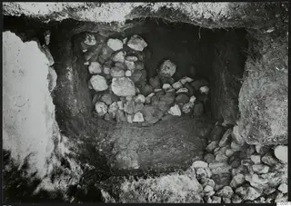Tomb 429 at Lapithos: burial chamber with a heap of stones during excavation