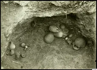 Excavated tomb chamber at Kylistra, Lapithos, with pottery vessels lying in situ