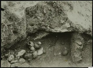 Pottery vessels in situ in an excavated tomb cavity at Kylistra, Lapithos