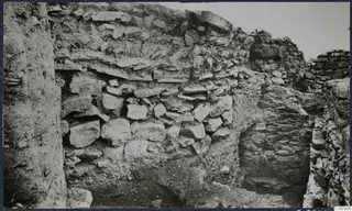 Excavated stone wall with an earthen face and a recessed opening at the Idalion acropolis