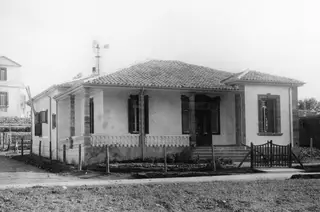 The Swedish house in Nicosia, a single-storey whitewashed building with a tiled roof and a columned veranda.