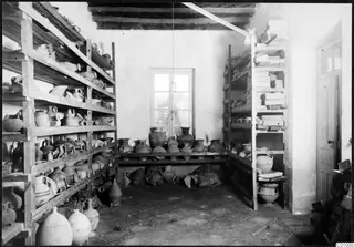 Storeroom at the Swedish Institute at Nicosia, with wooden shelves full of pottery vessels