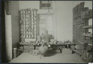 Storeroom in the Swedish Institute in Nicosia with a bust, terracotta heads and a large jar on a bench