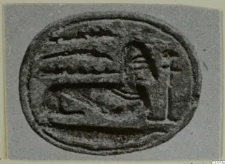 Oval engraved seal with a raised design of bands and an upright figure-like form, photographed on grey card