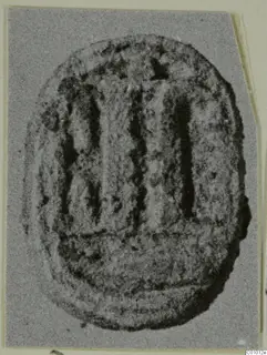 Glyptic: scarab-shaped seal of stone with incised markings, shown in close view