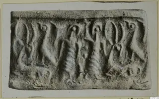 Rolled impression of a cylinder seal with carved figures and motifs in relief