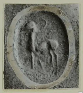Engraved oval stone seal from Vouni, showing a standing figure and a four-legged animal in worn relief