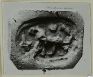 Seal impression with clipped corners, showing a low-relief figure with legs inside a raised border