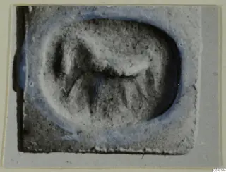 Seal impression, glyptic find from Idalion, with a raised figure inside an oval field