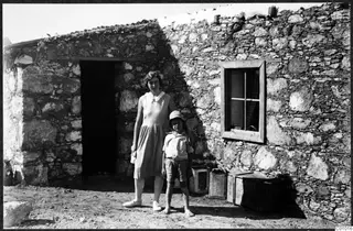 Mrs Gjerstad and Martin Gjerstad standing outside a stone house at Vouni
