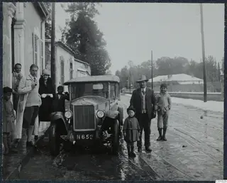 Group of people beside an early car on a snowy street in Nicosia