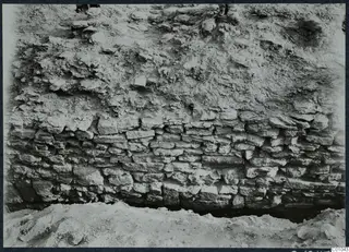 Stone wall of flat stones laid in courses, exposed during excavation at Idalion Acropolis