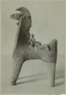 Terracotta figure of a horse with a small rider seated on its back, shown against a plain pale background.