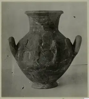 Two-handled jar with a flared rim and raised relief decoration on the body, photographed against a plain grey backdrop