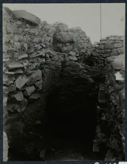 Excavated stone walls framing a dark passage opening at Idalion acropolis