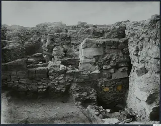 Excavated stone walls on the Acropolis at Idalion, with rubble and bare soil in the foreground