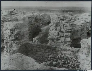 Exposed stone and earth walls of ruins on the Idalion acropolis, with a flat plain beyond.