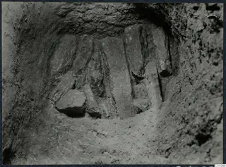 Excavated cut at Idalion with upright flat stone slabs set side by side against the back wall