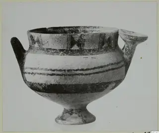 White Painted I bowl with two handles and dark painted bands, shown against a pale background