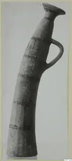 Horn-shaped White Painted II pottery vessel with a flared rim and single loop handle, from the Kastros tombs at Lapithos.