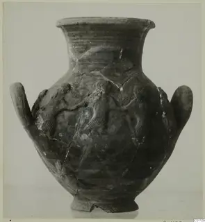 Two-handled pottery jar with relief figures on its body, shown from the front against a plain background.