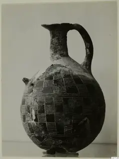 Red Polished II jug from the Vrysi tou Barba tombs at Lapithos, with incised checkerboard pattern and strap handle