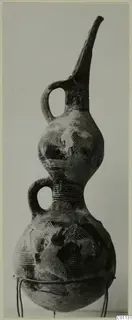 Red Polished III amphora, a double-gourd vessel with a tall spout and two loop handles, incised with chevrons and bands