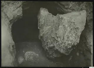 Tomb 5 at Marion during excavation, with large fallen stones in a rock-cut opening