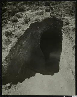 Tomb 12 at Marion during excavation, showing a cut leading down to a dark tomb opening