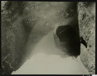Sloping cutting at Marion leading to a dark tomb entrance, during excavation