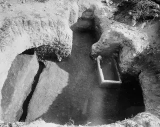 Tomb 15 at Marion, interior seen from the dromos, with a rectangular stone trough set in the floor of the cut.