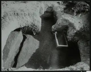 Tomb 15 at Marion, interior seen towards the dromos, with a rectangular pale stone trough and cut stone slabs beside it