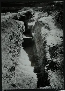 Tomb 14 at Marion during excavation, showing stone steps descending a narrow cut between earth banks.