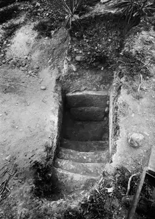 Tomb 16 at Marion: a flight of stone steps in a dromos leading down to the blocked entrance of the tomb