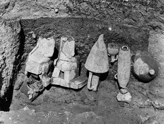 Sculpture fragments and pottery vessels lying in situ in Tomb 30 at Marion