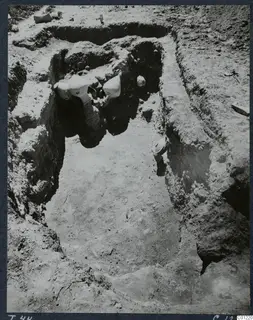 Tomb 44 at Marion during excavation, with pale pottery vessels lying in the cut