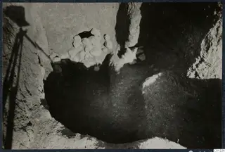 Tomb 40 at Marion during excavation, with a heap of pale stones in the cut