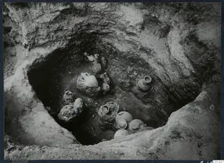 Interior of Tomb 47 at Marion seen from above, with pottery vessels and a possible skull on the tomb floor
