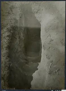 Tomb 51 at Marion: a narrow excavated cutting with stone steps descending toward a dark opening