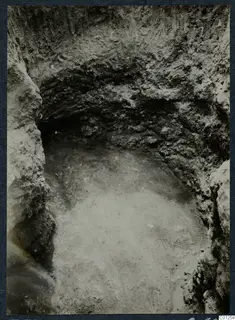 Tomb 31 at Marion during excavation, seen from above with curved cut walls and a pale floor