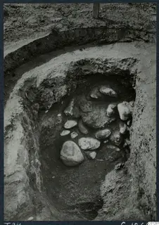 Tomb 24 at Marion: excavated pit with a cluster of stones in the fill