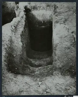 Tomb 34 at Marion during excavation, showing a rectangular cut descending in steps toward a dark opening.