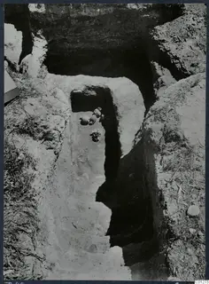 Tomb 48 at Marion during excavation, with vessels lying on the floor of a cut passage leading to the tomb.